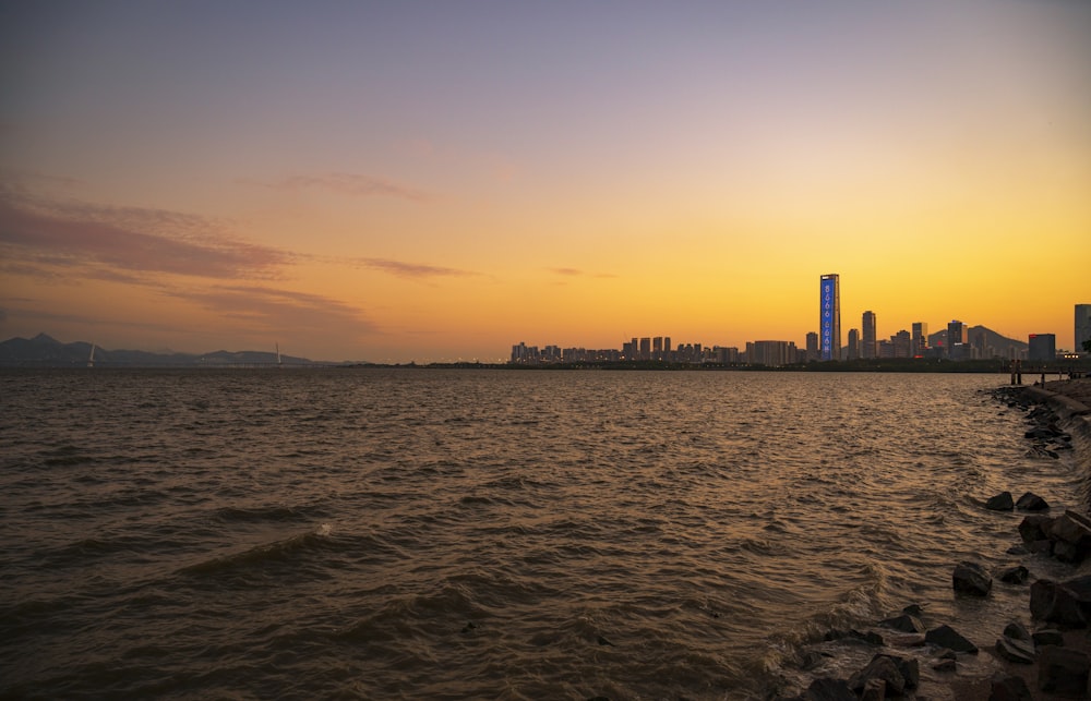 the sun is setting over the city skyline