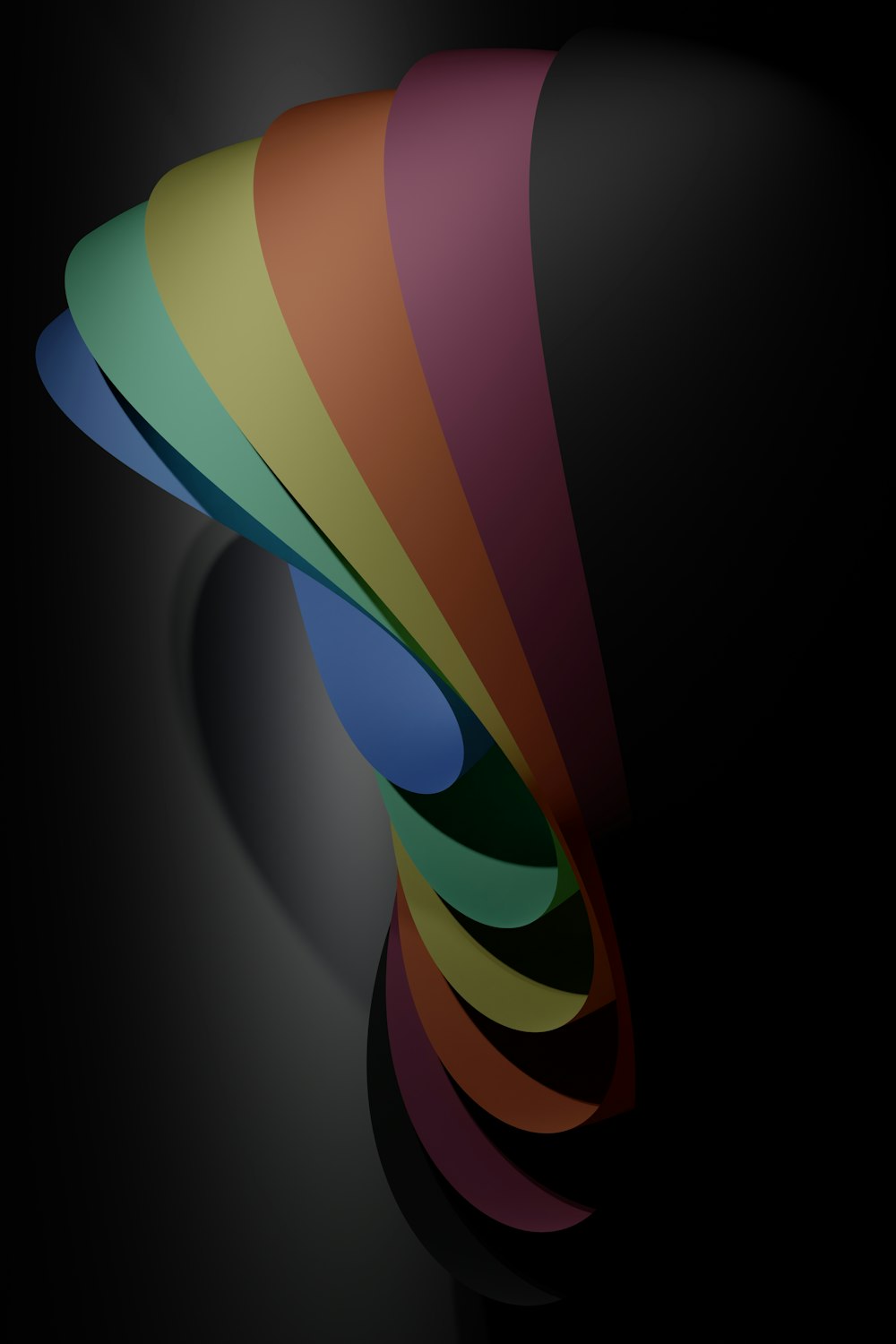 a rainbow colored object on a black background