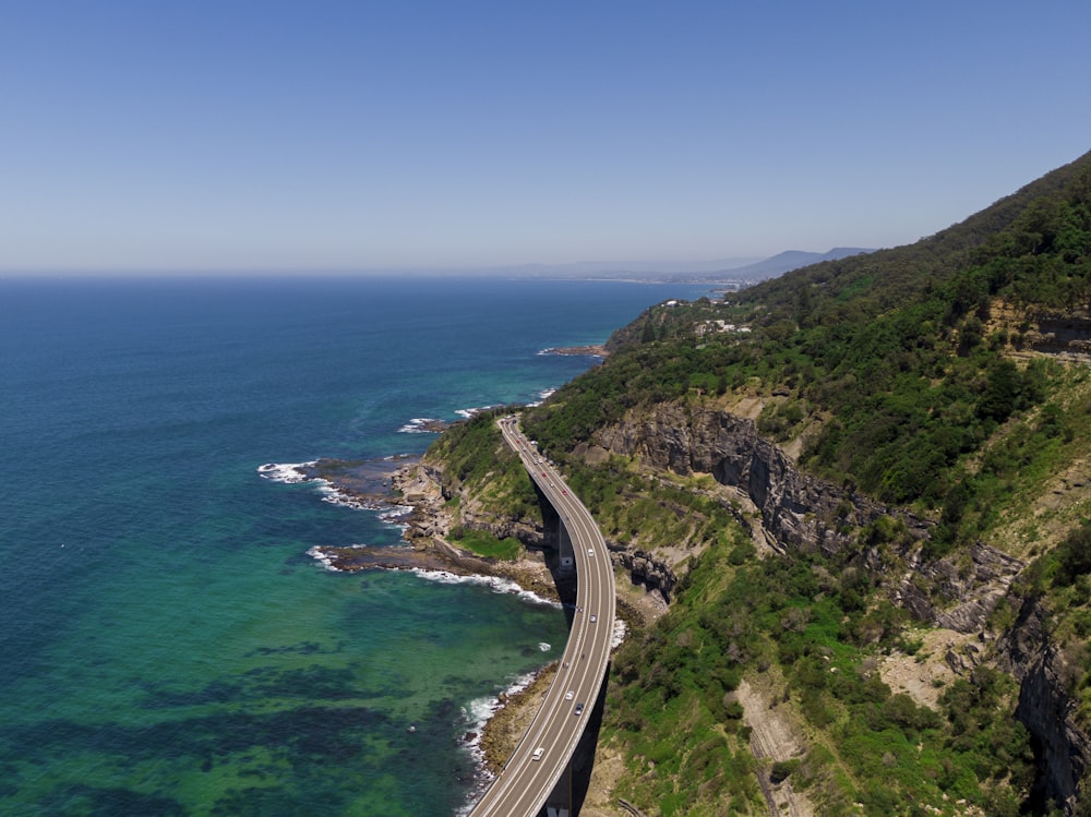 an aerial view of a highway next to the ocean