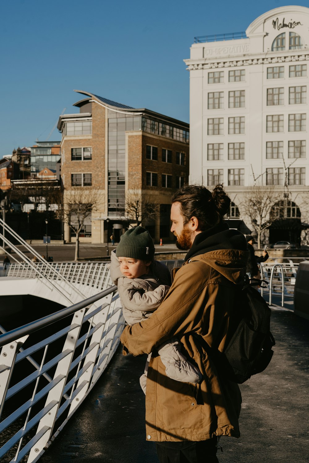 a man and a child standing on a bridge