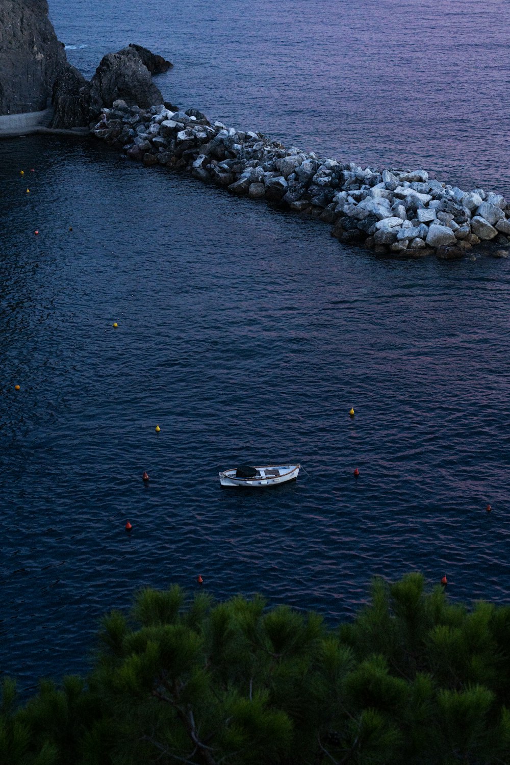 a small boat floating on top of a body of water