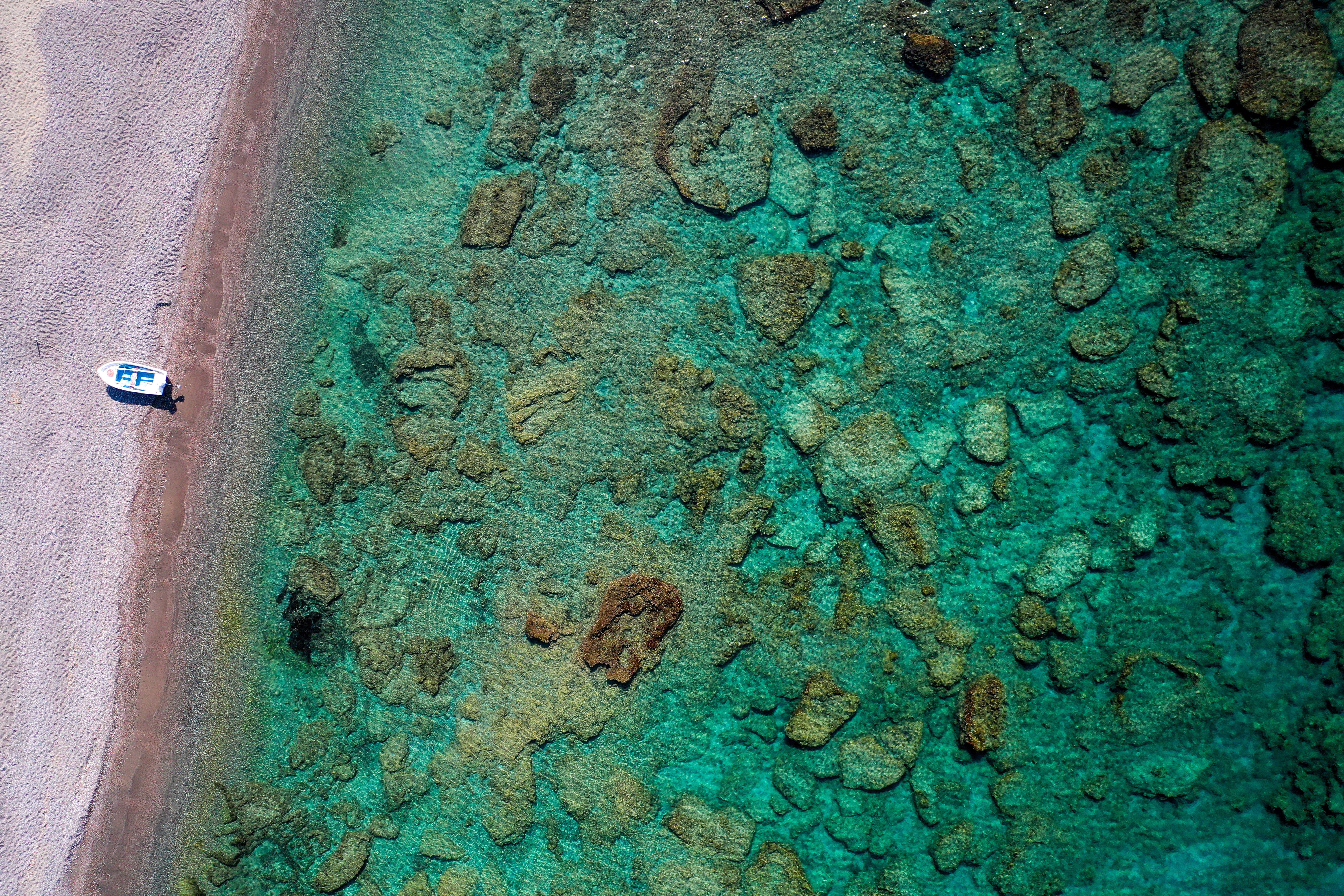 an aerial view of a boat on a beach