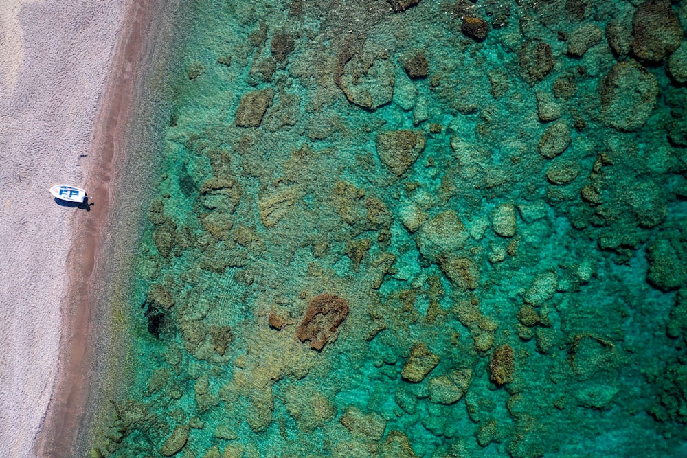 an aerial view of a boat on a beach