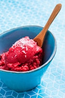 Close-up of creamy coconut cascinha (sorbet) in a natural wooden bowl