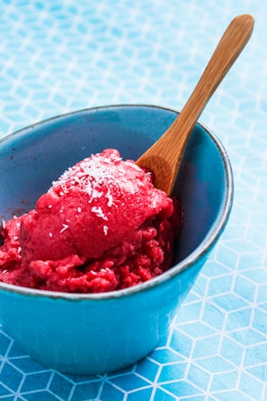 Close-up of creamy coconut cascinha (sorbet) in a natural wooden bowl