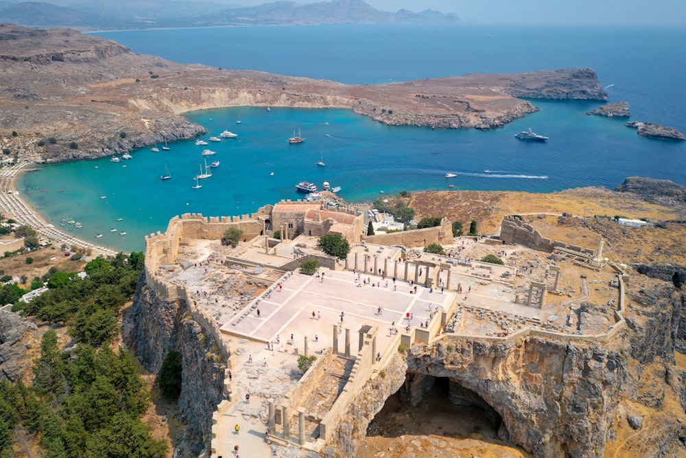 an aerial view of a castle overlooking a body of water