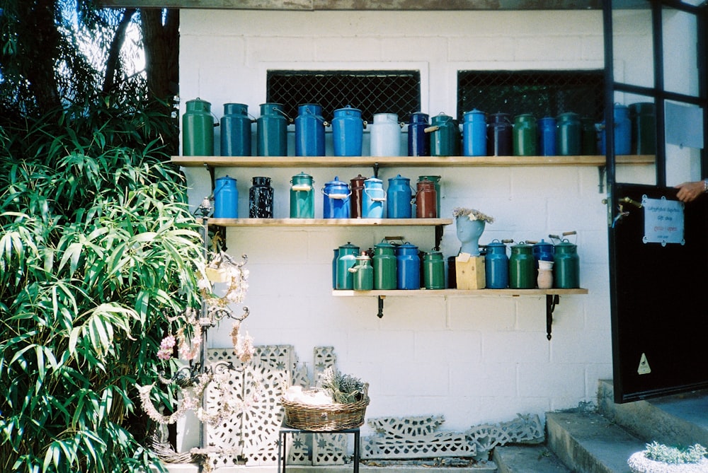 a shelf filled with lots of blue and green containers