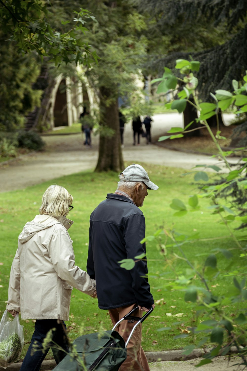 a man and a woman walking in a park