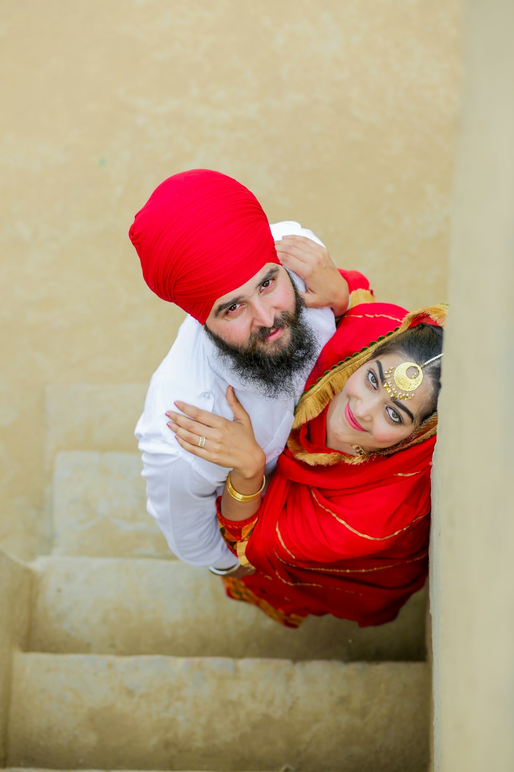 a man in a turban and a woman in a red dress