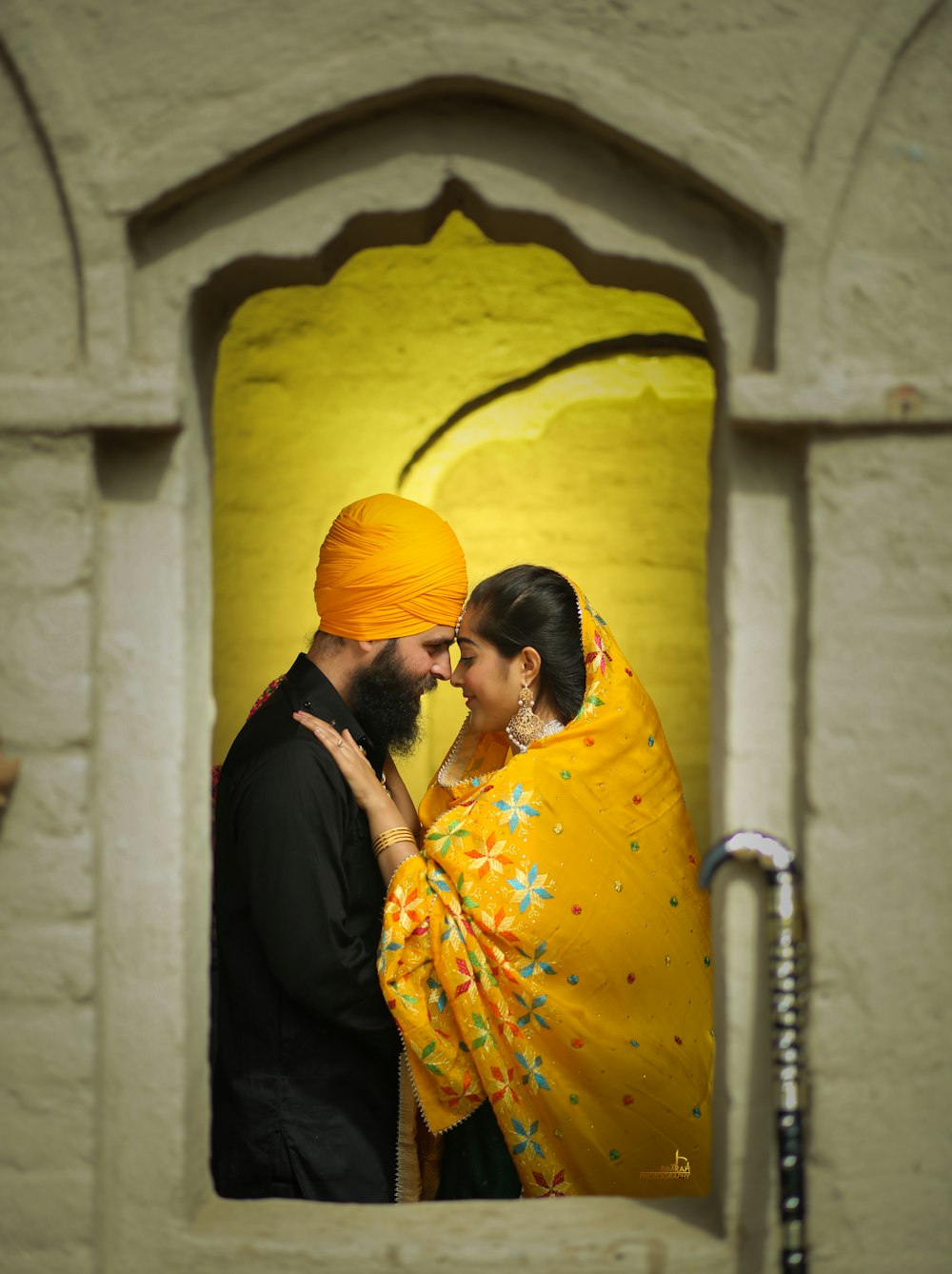 a man and a woman in a yellow turban