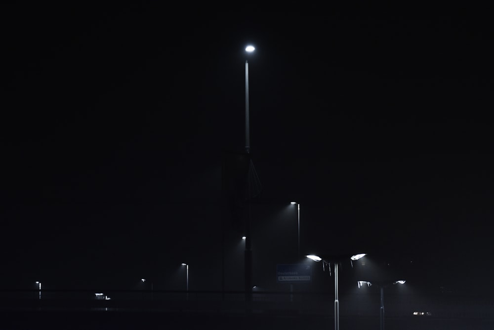 a black and white photo of a street at night