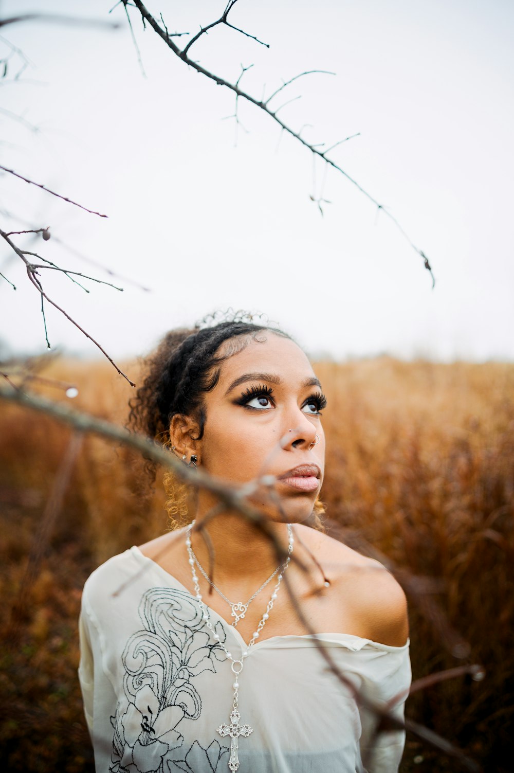 a woman standing in a field of tall grass