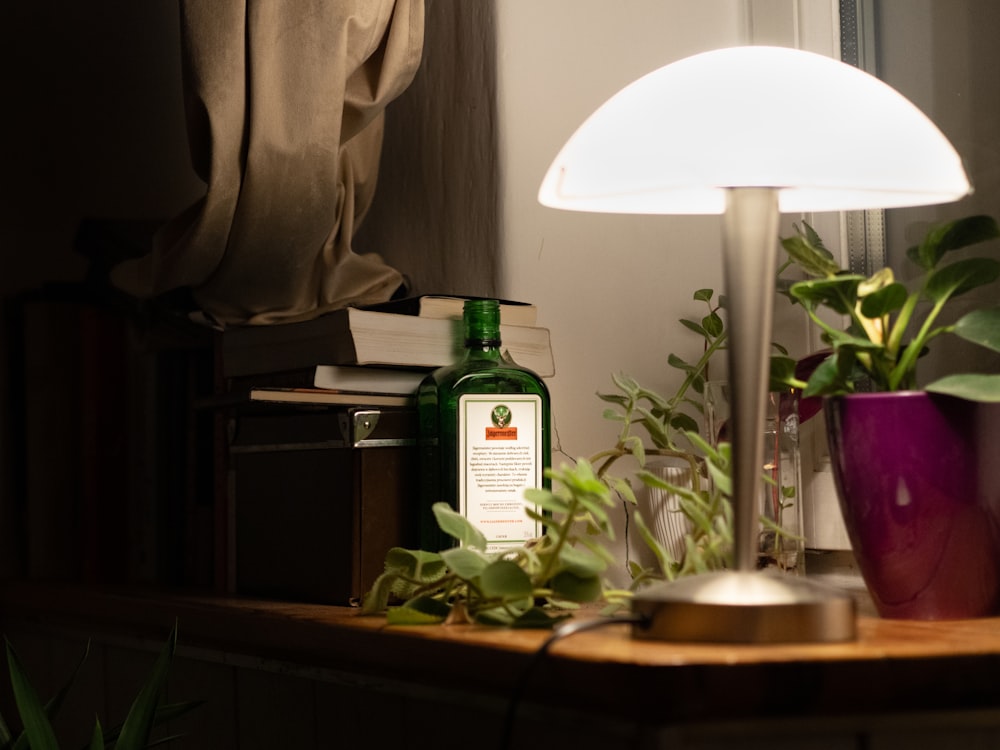 a table with a lamp and a bottle on it