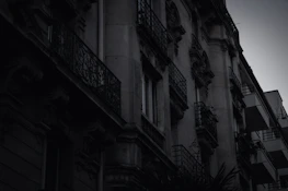 Moody architectural detail of a cliffside estate with sharp lines and deep shadows.