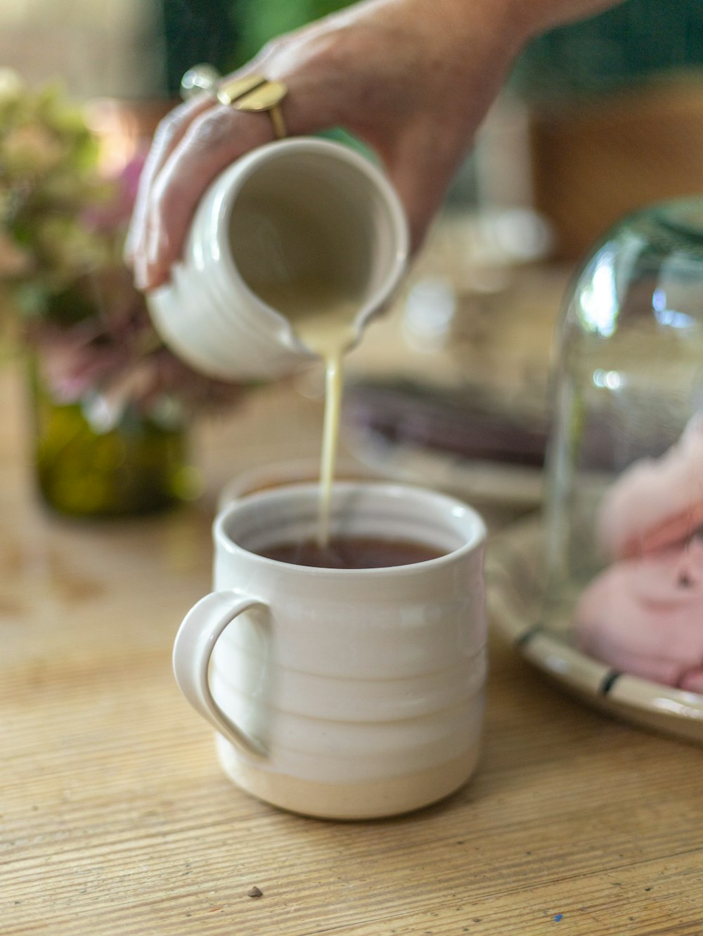 a person pours coffee into a mug