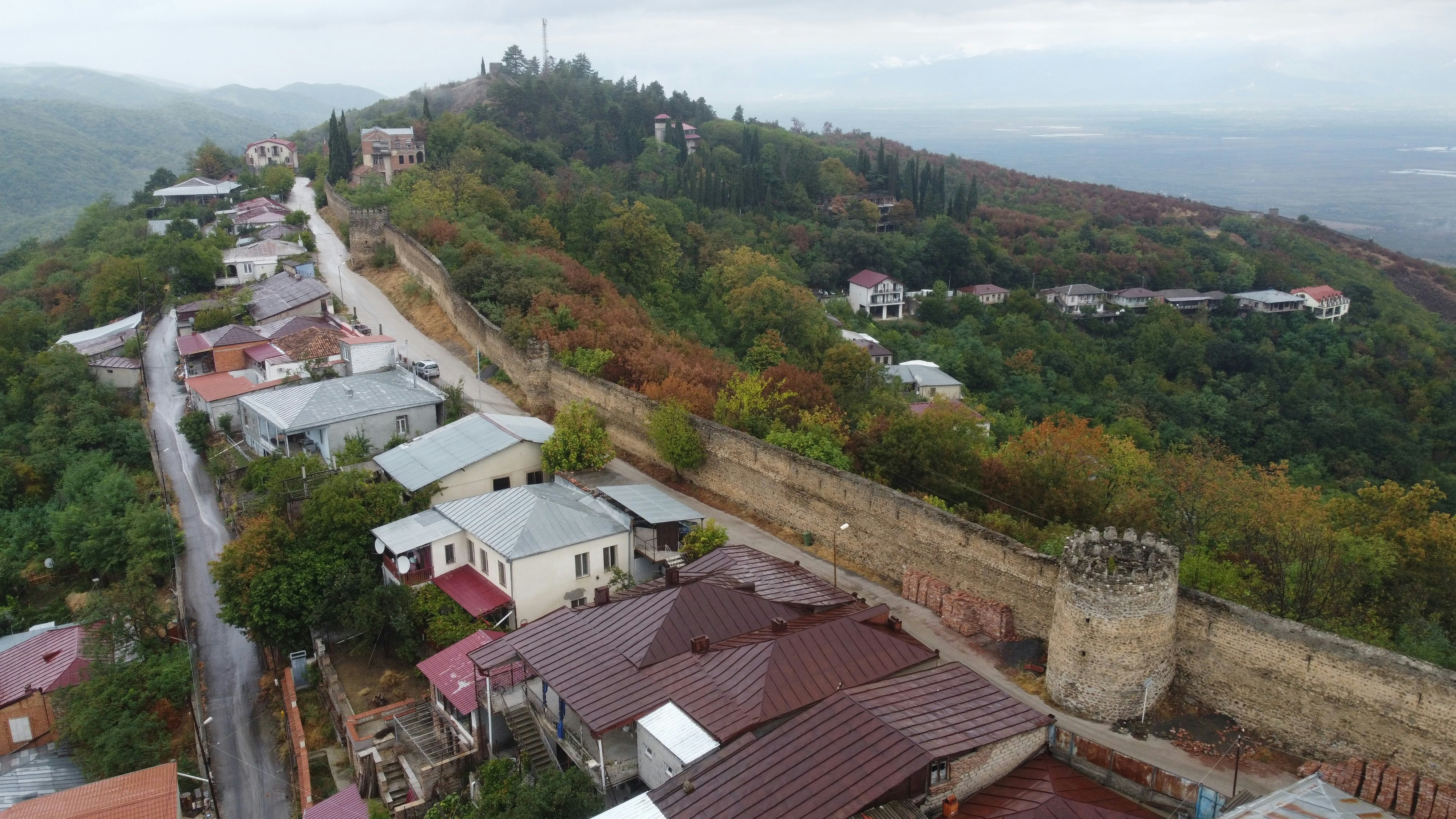 an aerial view of a small town on a hill