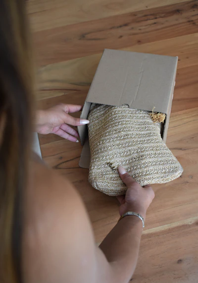 a woman is opening a purse on the floor