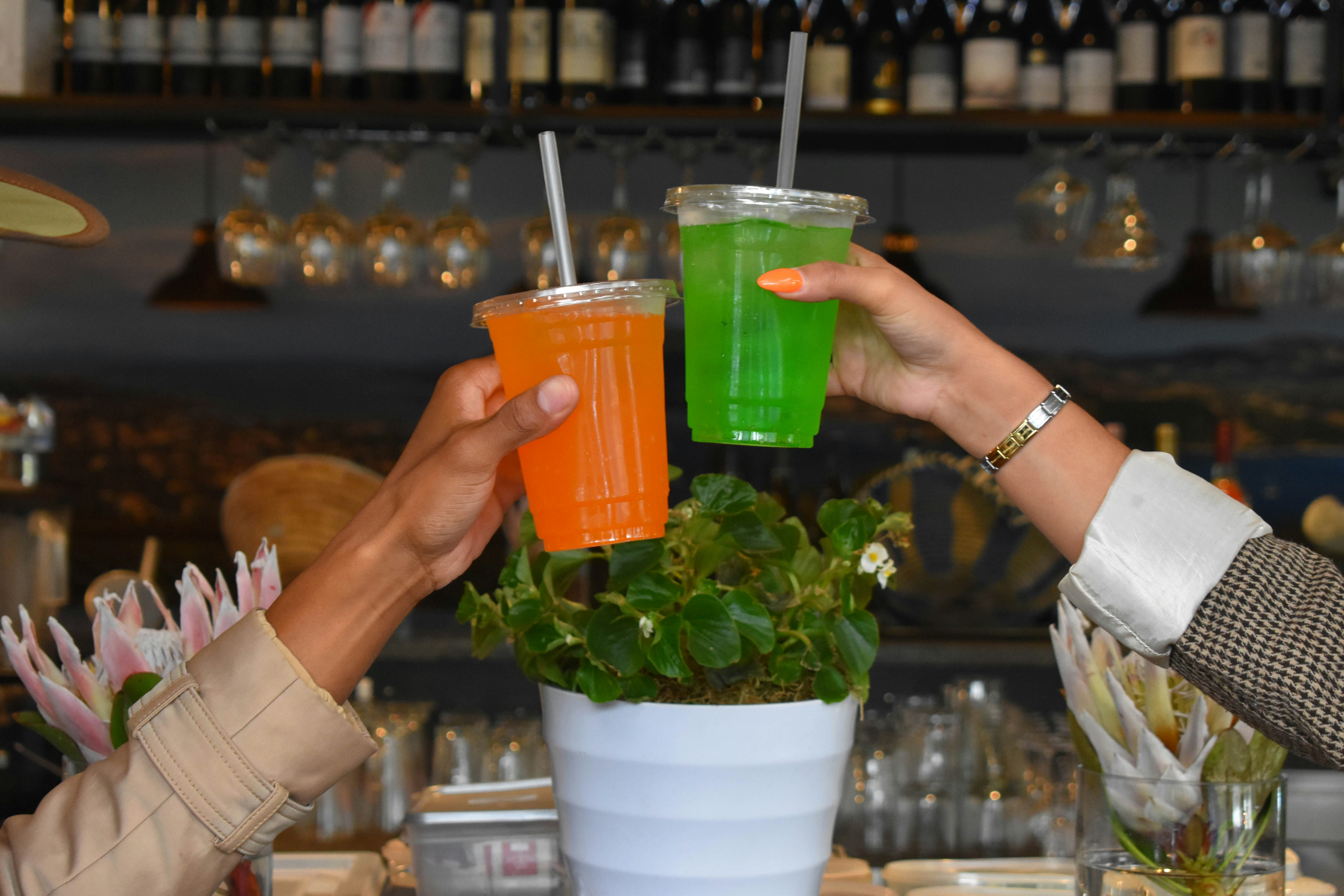 a couple of people that are holding drinks