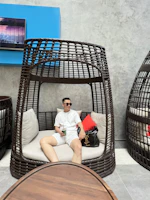 An elegant traveler enjoying a quiet moment on a velvet blue lounge chair.