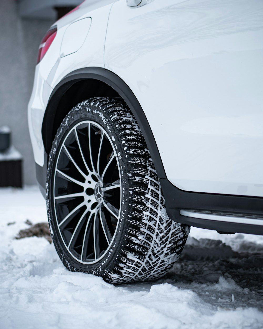 a white car is parked in the snow