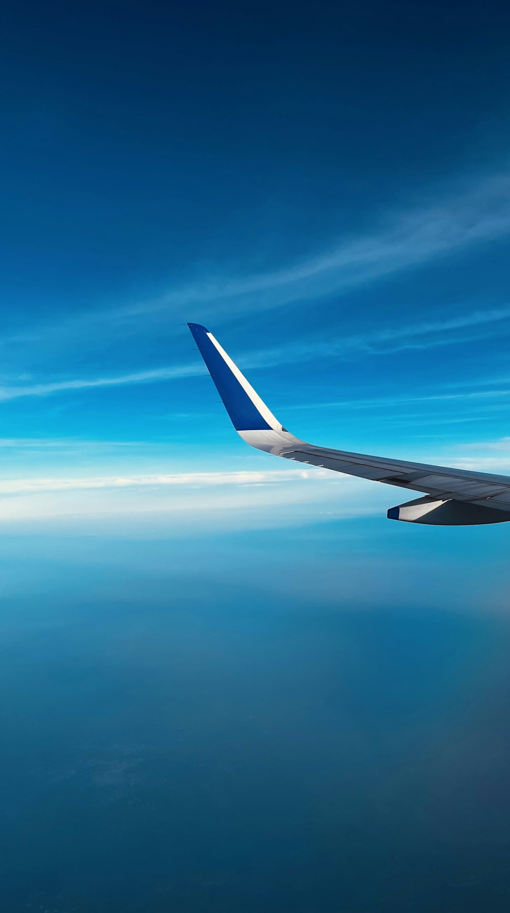 a view of the wing of an airplane in the sky