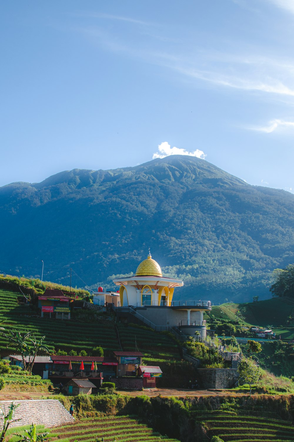 a scenic view of a mountain with a yellow dome