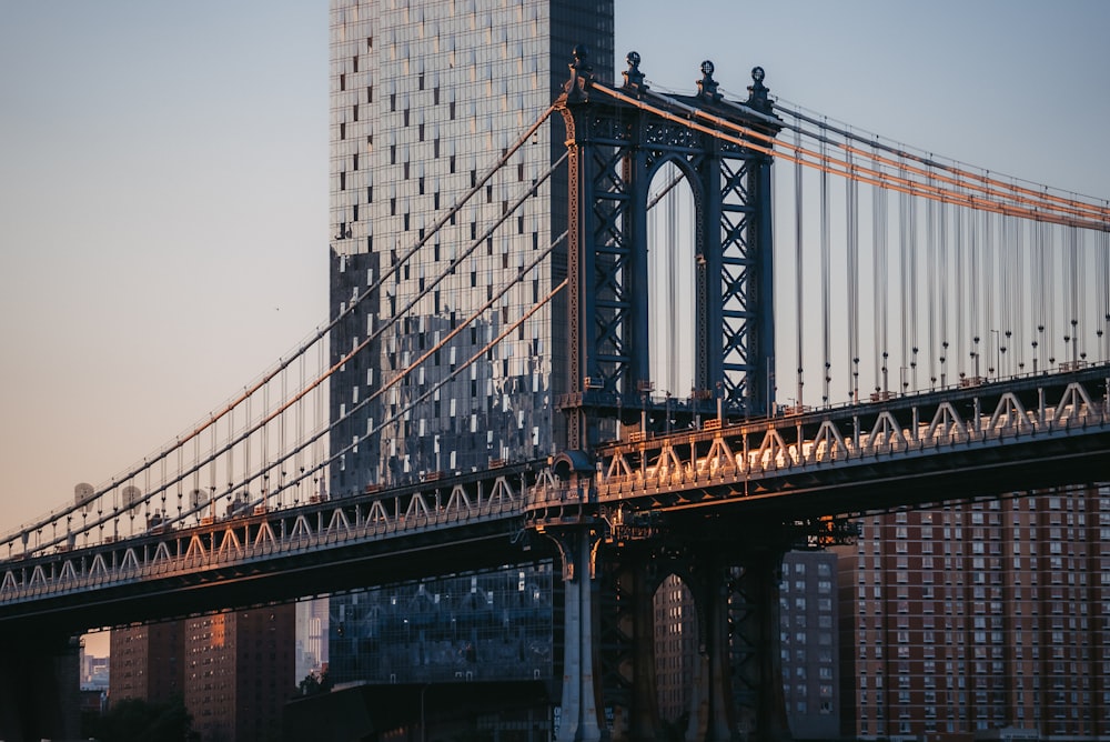 a very tall bridge with a very tall building in the background