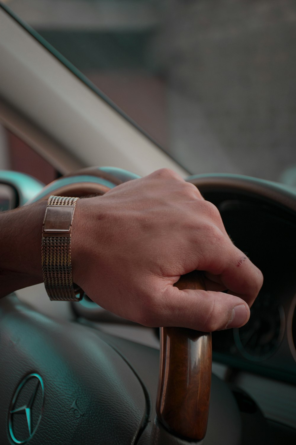 a person's hand on the steering wheel of a car