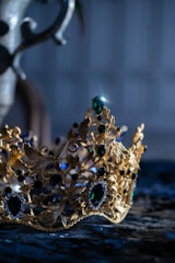 A vintage-style illustration of a Brazilian imperial crown resting on an old book with olive green and yellow tones.