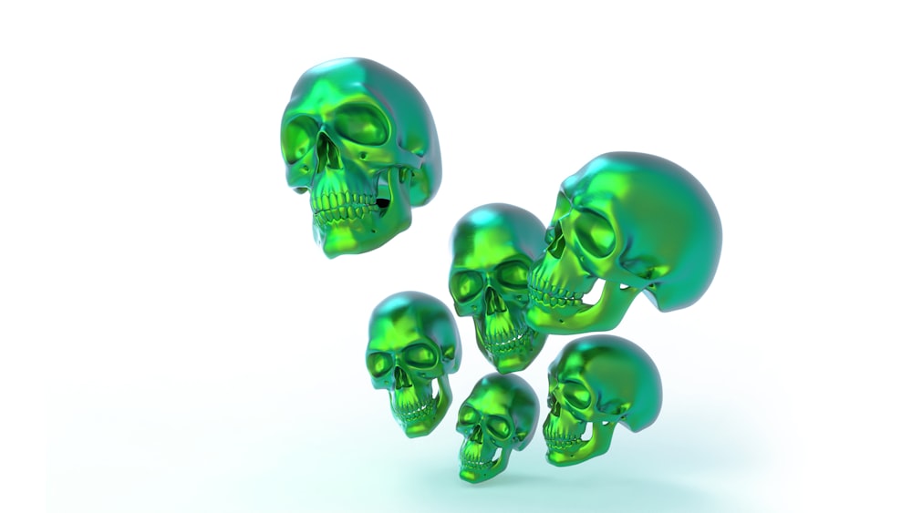 a group of green skulls sitting next to each other
