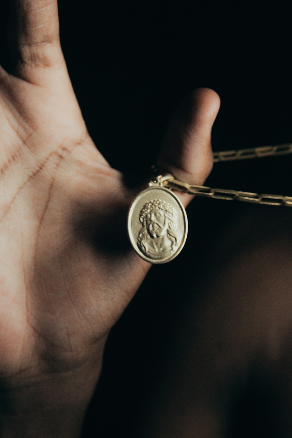 a person holding a gold coin in their hand