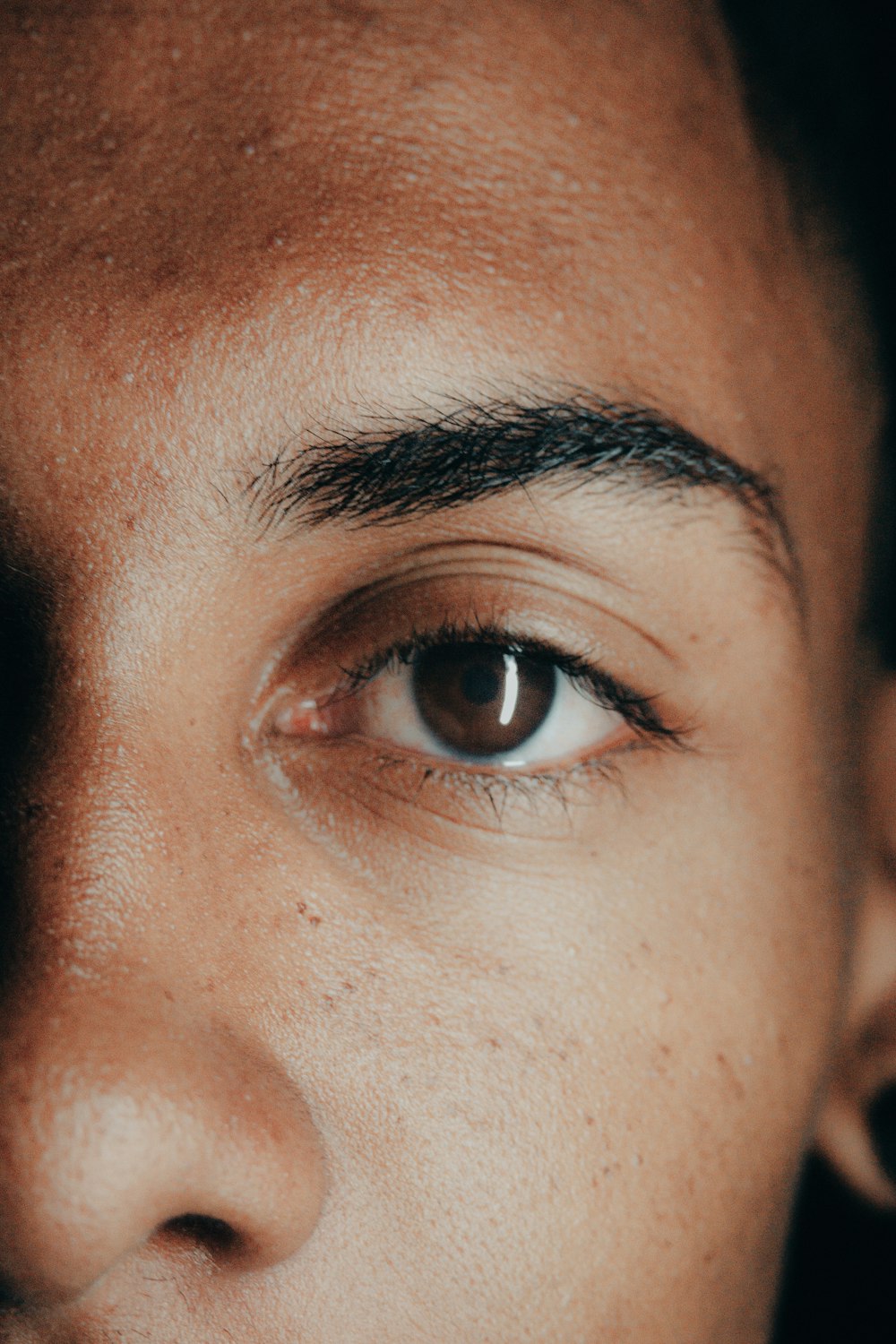 a close up of a man's face with a toothbrush in his mouth