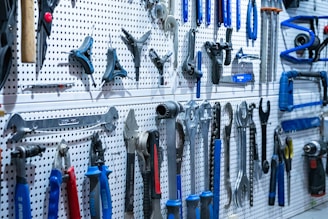 a bunch of tools hanging on a wall