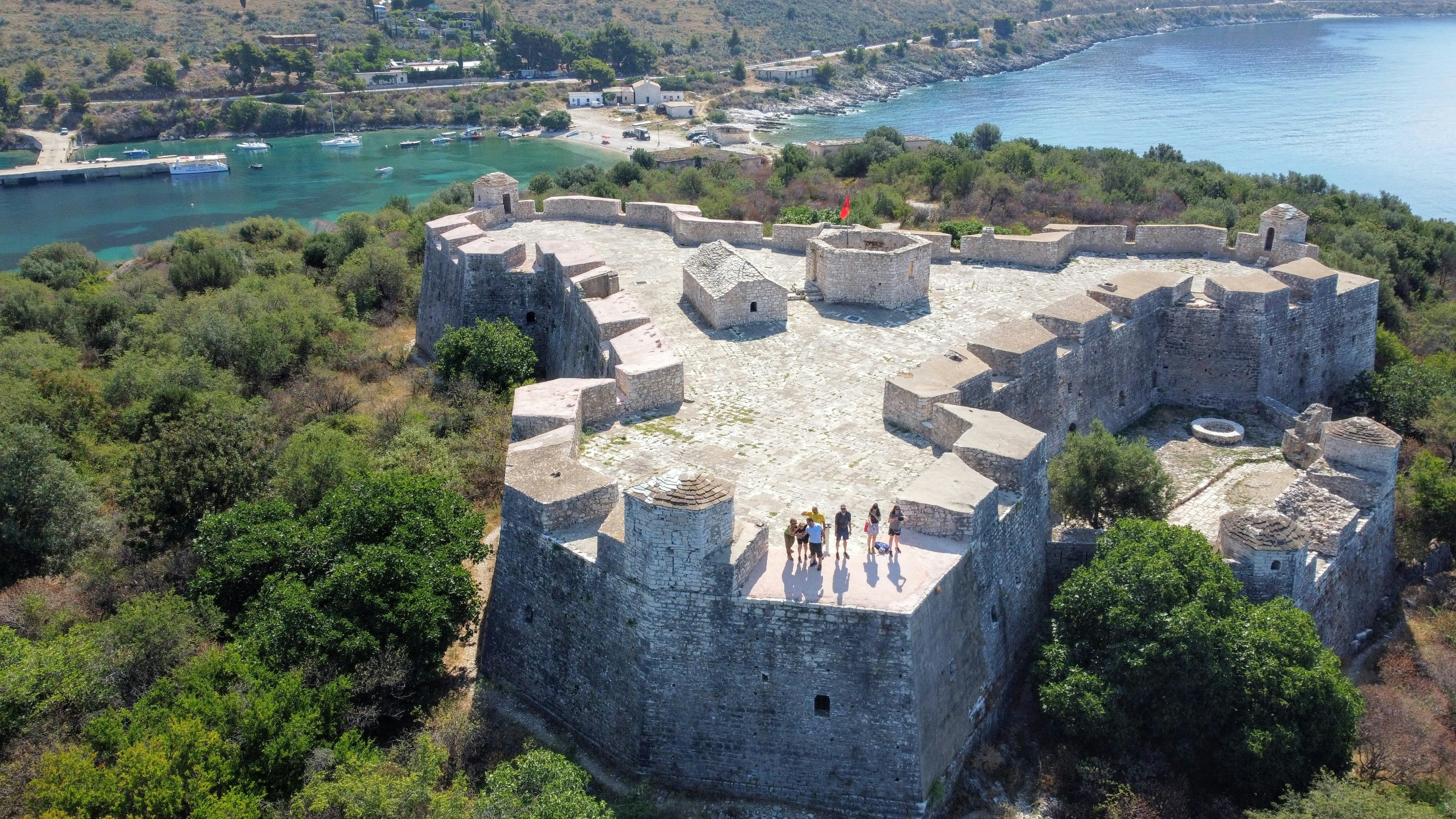 a group of people standing on top of a castle