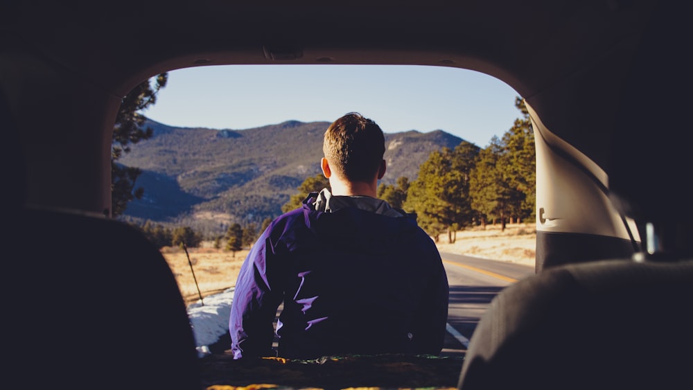 a man sitting in the back of a truck