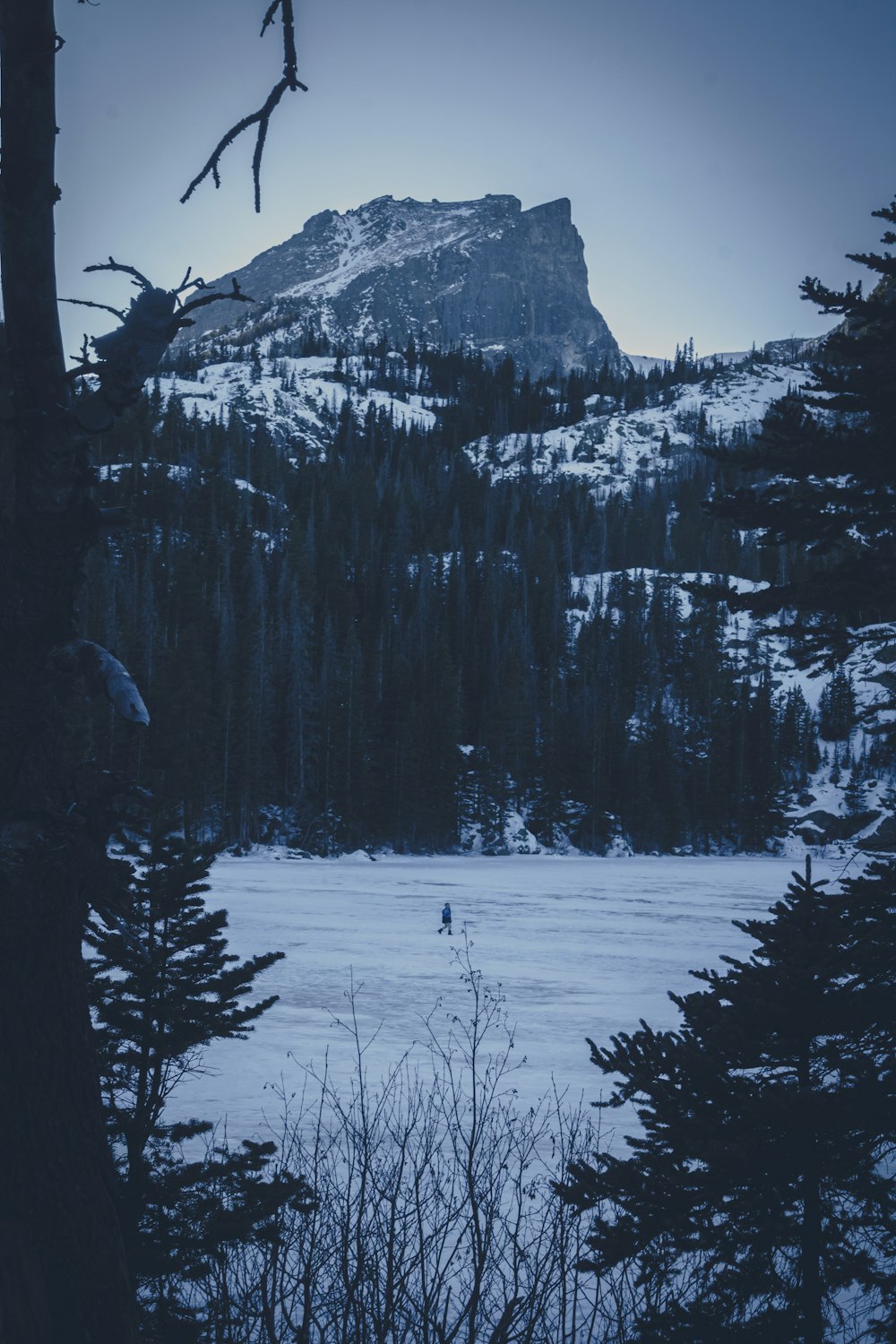 a person is skiing in the snow near a mountain