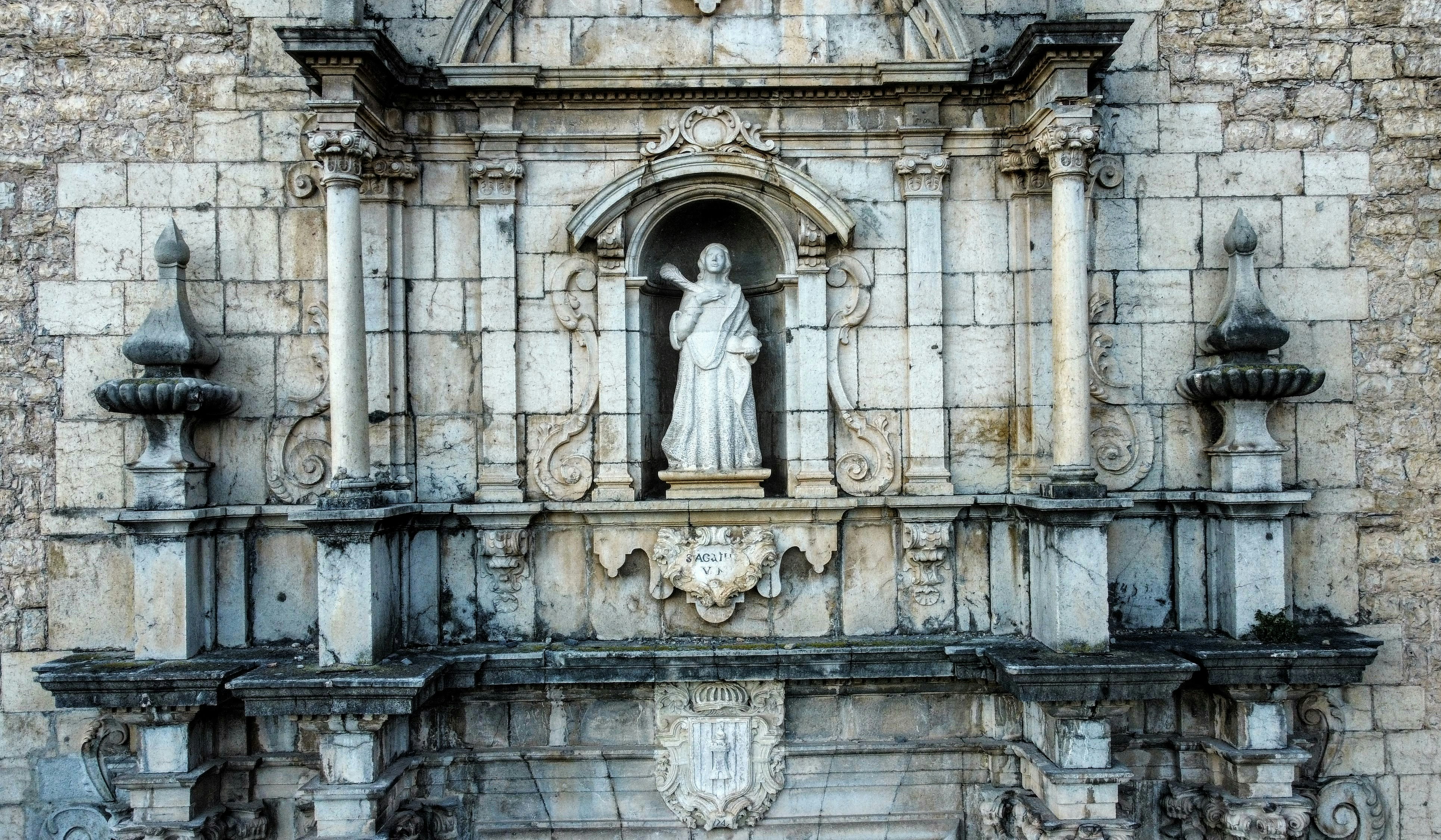 a statue of a woman in a window of a building