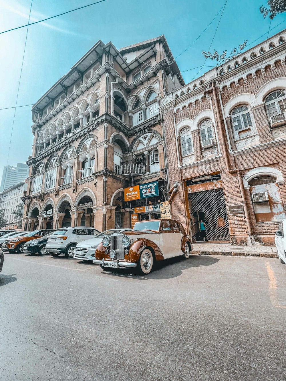 an old car parked in front of a building