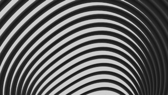 a black and white photo of a spiral design