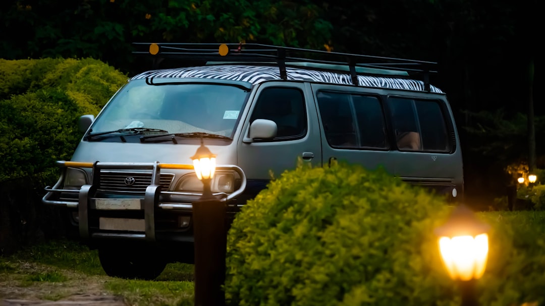 a van is parked in the dark with its lights on, A tourist van parked in Silverback Lodge in Bwindi Impenetrable Forest