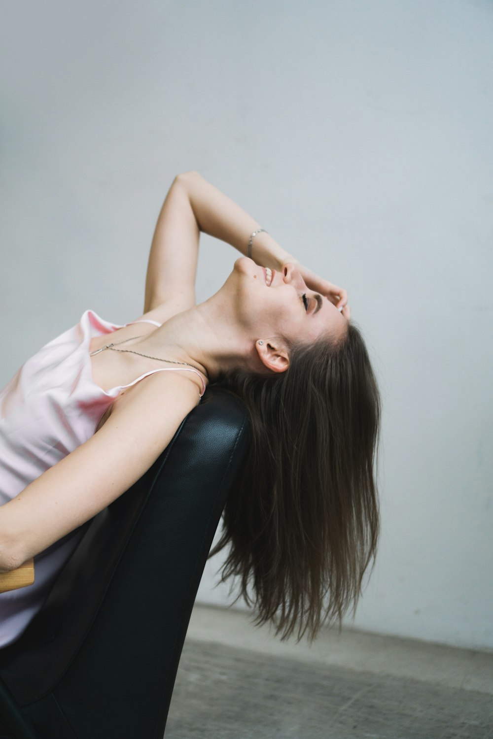 a woman sitting in a chair with her head on her back