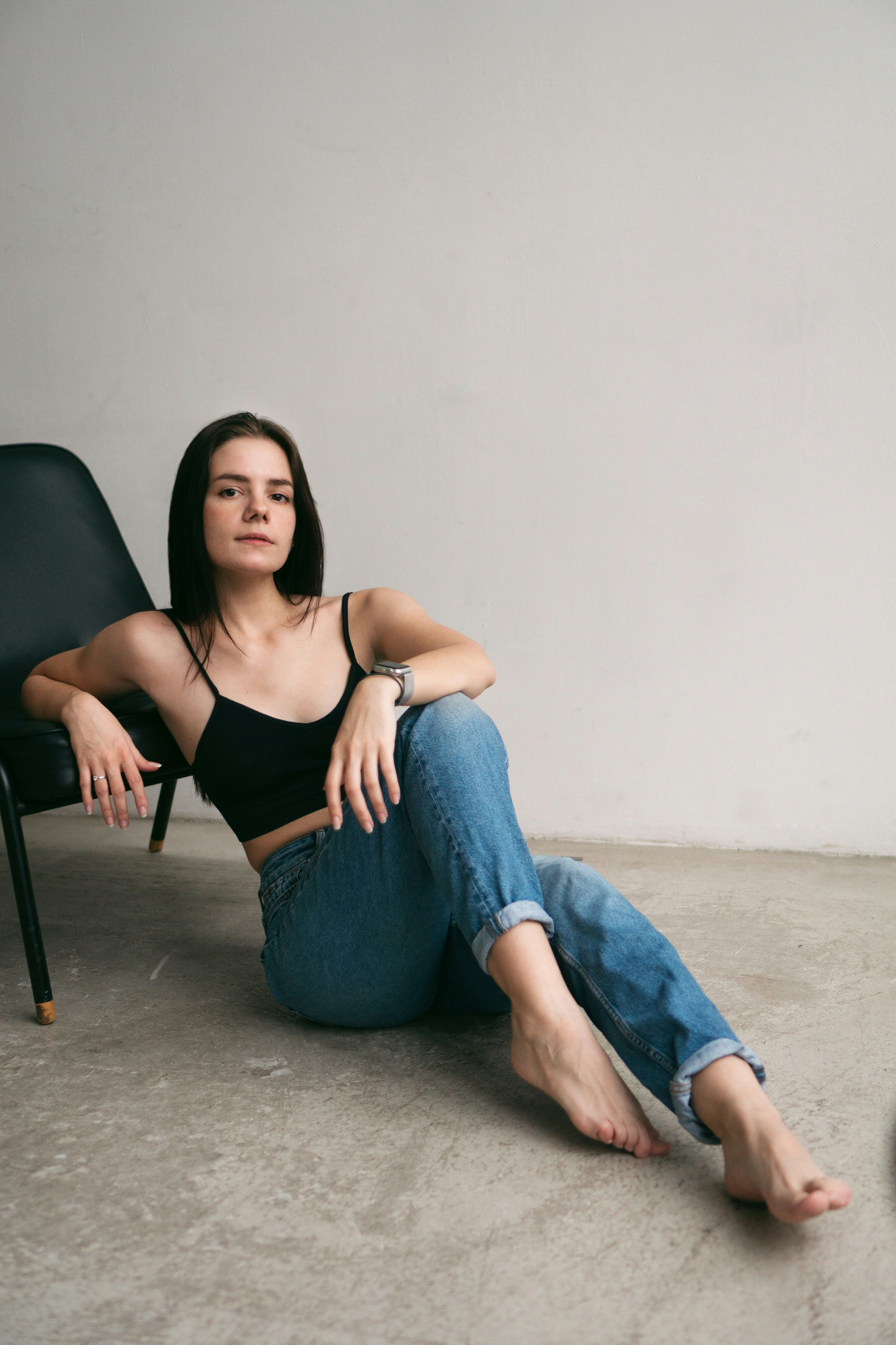 a woman sitting in a chair with her legs crossed