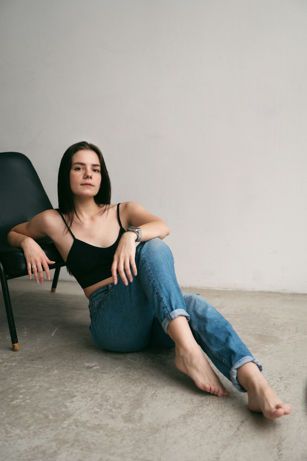 a woman sitting in a chair with her legs crossed