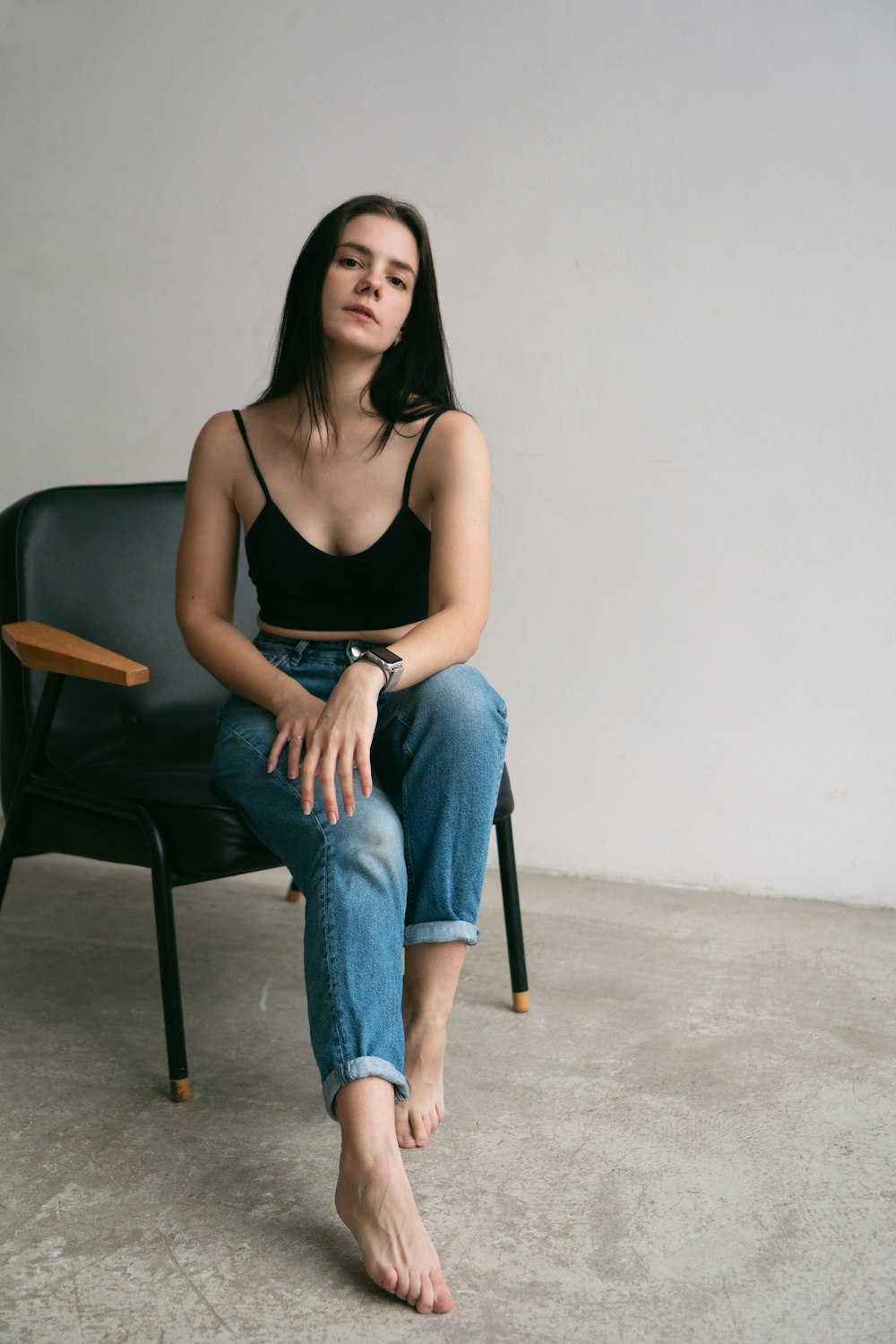 a woman sitting on a chair with her legs crossed