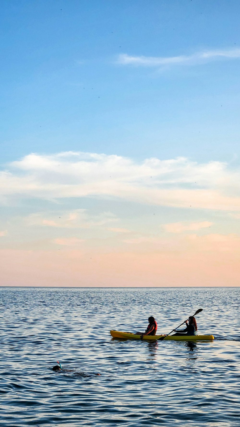 a couple of people on a kayak in the water