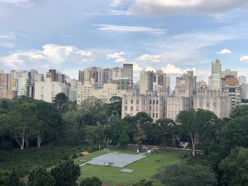 a tennis court in the middle of a city park