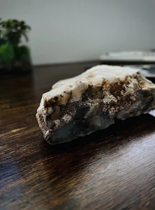 Close-up of rich, dark Himalayan shilajit resin on a natural stone surface.