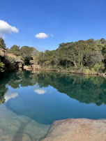 Clear blue sky framing the serene Kodaikanal lake on a sunny day