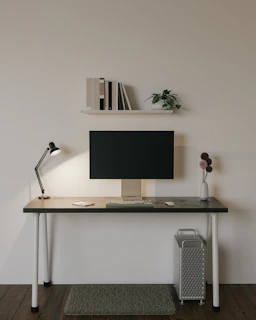 A minimalist desk featuring a compact computer tower and sleek accessories.