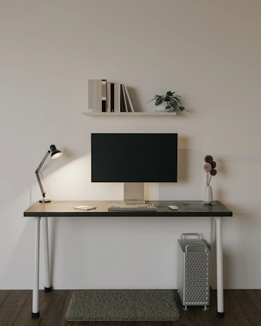 A minimalist desk featuring a compact computer tower and sleek accessories.